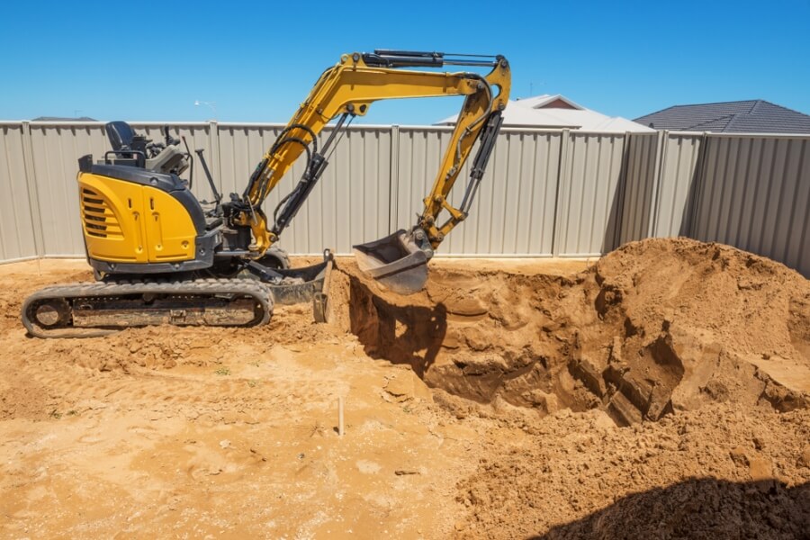 Excavator digging a pool hole